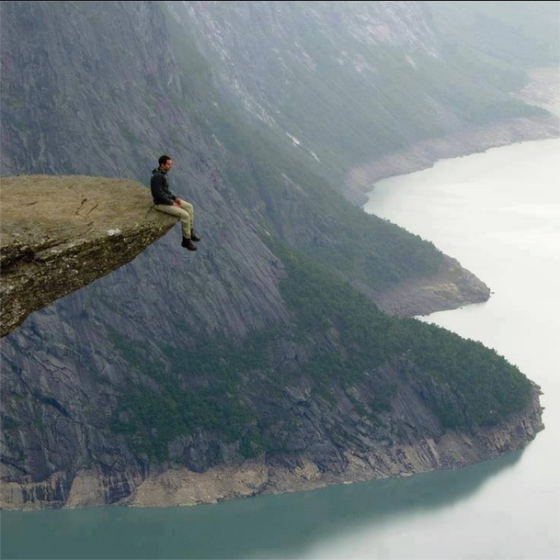 sitting at the edge of a cliff